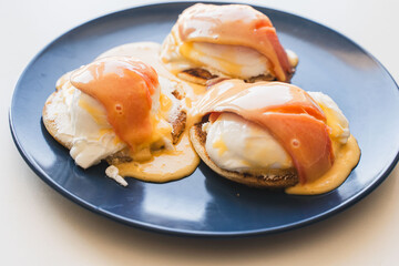 Breakfast with salmon and egg benedict on a toasted bun. Healthy breakfast in the morning on the...