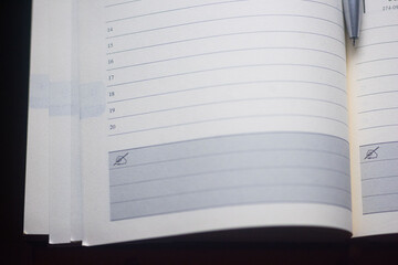 Open journal with notes section warm light illuminating blank pages on a dark table