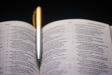 Open Christian Bible with a pen depicting Bible study and fellowship