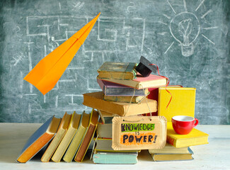 knowledge is power, arrangement of books, a paper plane and sign for learning,inspiration and...