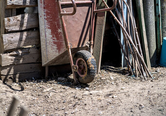 Old rusty wheelbarrow in a rural yard