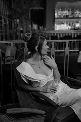 A young couple in wedding looks posing in a stylish loft bar.