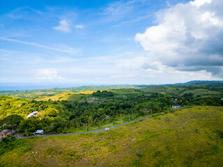 Aerial view of tropical savanna Hill at Nusa Penida , Bali Indonesia. Drone shot scenery of valley / hills at Nusa Penida Bali