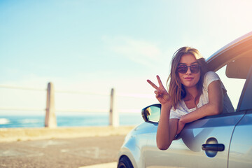 Woman, car and sunglasses by window in summer for travel, freedom and vacation with sunshine by beach. Girl, motor and parking by ocean as driver for road trip, holiday and adventure in San Francisco