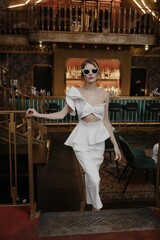 A young couple in wedding looks posing in a stylish loft bar.