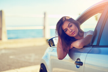Woman, car and portrait by window in summer for travel, freedom and vacation with sunshine by...