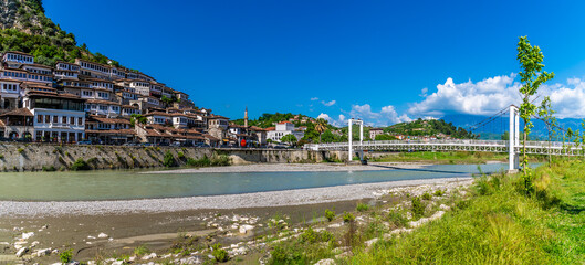 A view across the River Osum and the pedestrian bridge in Berat, Albania in summertime