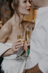 A young couple in wedding looks posing in a stylish loft bar.