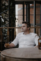 A young couple in wedding looks posing in a stylish loft bar.