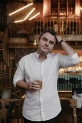 A young couple in wedding looks posing in a stylish loft bar.