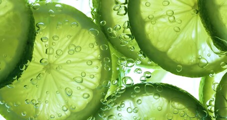 Lime Slices falling deeply under water. Shot on super slow motion camera 1000 fps.