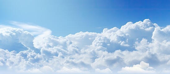 A serene backdrop featuring a nature scene with soft evening light illuminating white clouds against a vivid blue sky perfect for a copy space image