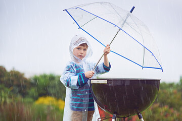 Grill, portrait and umbrella for rain with boy outdoor in nature filed, camping, cooking or...