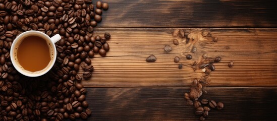 A top down perspective of cups of steaming hot coffee and aromatic coffee beans placed on a brown wooden surface with ample copy space for an image - Powered by Adobe