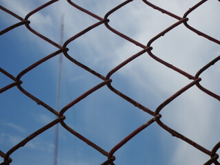mesh wire fence with sky as background