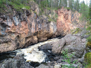 Beautiful red cliffs  coast and mountain river in summer Kuusamo, August 12, 2020