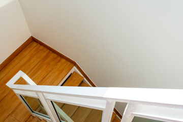 Modern wooden and glass staircase in new house interior.