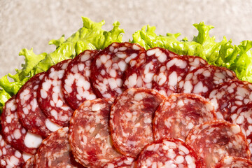 Thinly sliced salami slices close-up.
