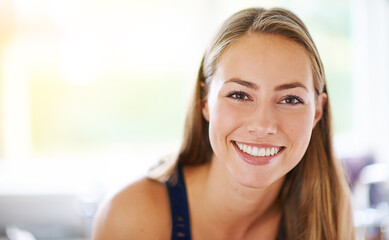 Portrait, young and woman at house with smile to relax in living room as student for spring break on weekend. Happy, carefree and female person with confident comfort in campus dorm for calm peace