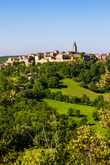 Obraz premium Village médiéval de Puycelsi, au sommet de son plateau rocheux et protégé par ses remparts du XIVe siècle, dominant la Forêt de la Grésigne
