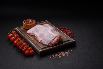 Raw chicken thighs with salt, spices and herbs