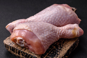 Raw chicken legs with salt, spices and herbs