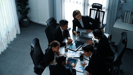 Top view of diverse business team discuss about marketing idea while businessman analyze financial...