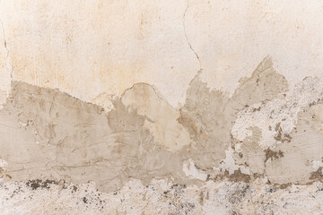 A wall in poor condition with patches of cement over the paint