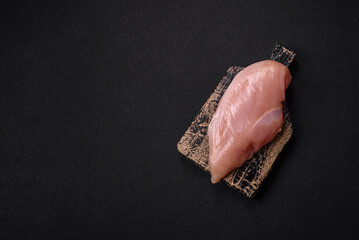 Raw chicken fillet with salt, spices and herbs