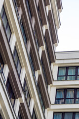 Skyscraper towering above urban design, framed by clear blue sky