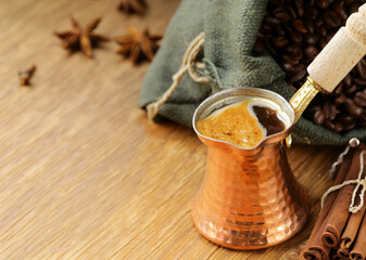 freshly brewed coffee in a cezve with cinnamon and anise