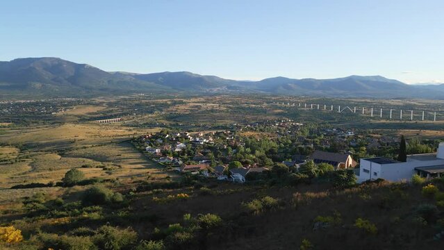 Mountain houses next to the mountains of Madrid on a clear day with blue skies, Spain.