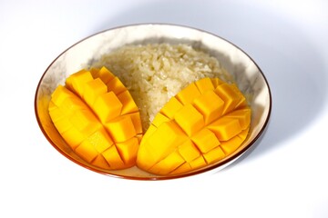 Mango and sticky rice with coconut milk sauce put on white background with isolated concept.