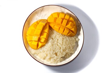 Mango sticky rice put on white background with isolated and top view concept.