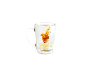 Inkling dropped in water glass put on white background with vintage style.