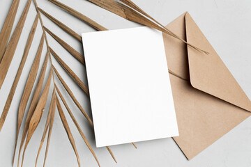 Invitation or greeting card mockup with palm tree leaf, blank card with copy space