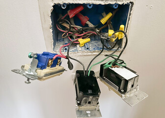 An electrical switch box on the inside with capped off wires