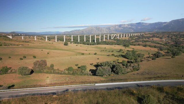 Mountain road next to the high-speed train bridge in the Sierra de Guadarrama, Madrid.