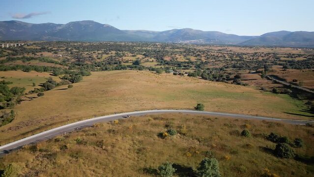 Mountain road where vehicles circulate next to the great mountain of Madrid, Spain.