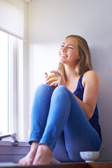 Home, thinking and woman with orange juice, window and smile with ideas, relax and happiness in lounge. Apartment, person and girl with nutrition, smoothies and break with decision, peace and calm