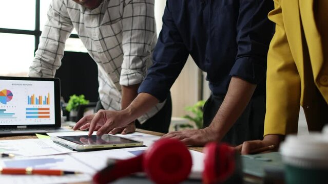 Colleague meeting with startup business team analyzing market situation and company growth. Meetings to discuss strategy analysis and business investment planning on modern digital tablet.