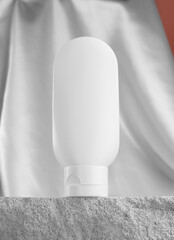 White plastic tube on a stone podium. Natural cosmetics brand mockup for moisturizer, body lotion
