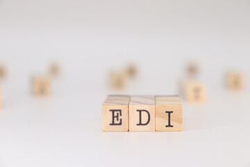 EDI acronym. Concept of Electronic data interchange written on wooden cubes isolated on white background.