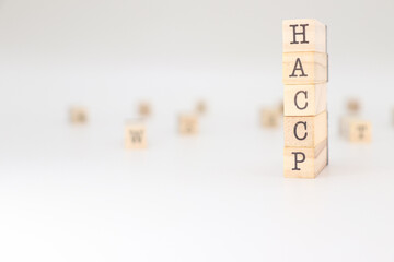 HACCP Acronym. Concept of Hazard Analysis and Critical Control Points written on wooden cubes isolated on white background.