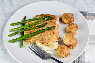 baked haddock served with asparagus and scallops