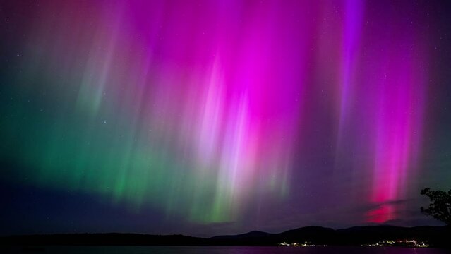 aurora australis taking on a sandy beach in a beach town in tasmania australia in winter