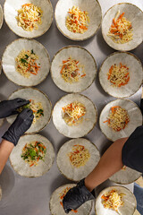 Close-up of a chef's hands arranging food