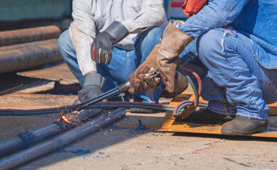 Cropped image of 2 welders using acetylene gas welding torch machine to welding galvanized steel...