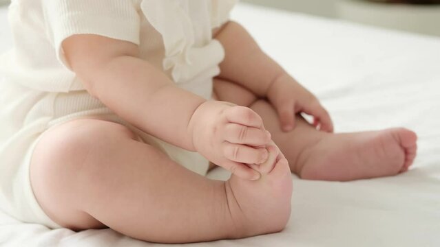 the legs of a small child on a white background on the bed, a pl