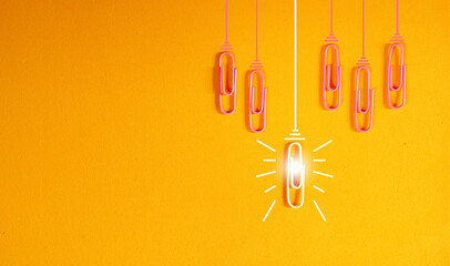 innovation concept with paperclip,thinking,creativity,light bulb on orange background,business and...
